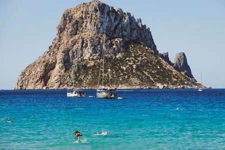 Cala Hort beach with sea sailing yachts and the mountain Es Vedra. Ibiza, Balearic Islands, Spainのeditorial素材