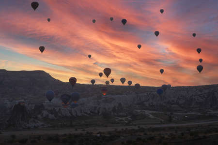 Cappadocia, Turkey - October 19, 2019: Colorful hot air balloons flying over the valley at Cappadocia. Hot air balloons are traditional touristic attraction in Cappadocia.のeditorial素材