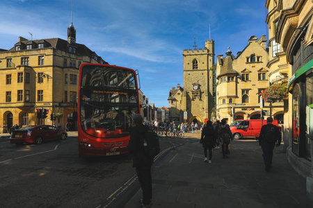 Oxford, United Kingdom - September 20, 2019: View of High Street and old Carfax Tower with double decker red bus in the city center, Oxford, Englandのeditorial素材