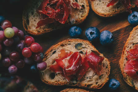 Selective foucs on ham jamon Bellota on wooden boardの写真素材