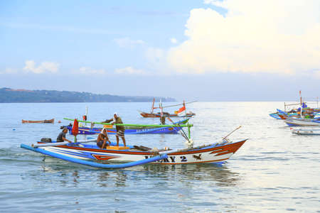 Bali, Indonesia - February 6, 2020: Colorful handcrafted Balinese wooden fishing boat at port in Jimbaran beach, Baliのeditorial素材