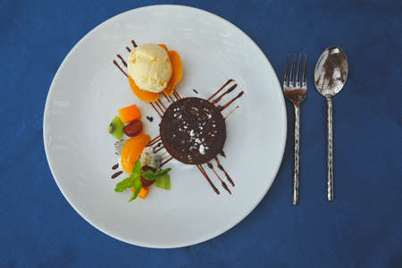 Classic Chocolate brownie served with fruits and vanilla ice creamの写真素材
