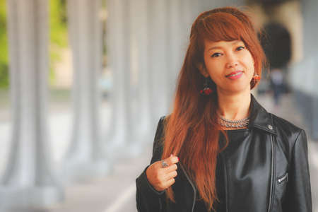 Portrait of Thai woman wearing leather black jacket, healthy life and vacation conceptの写真素材
