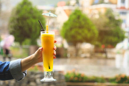 Woman hand holding a glass of fresh pineapple juice, detox Juice conceptの写真素材