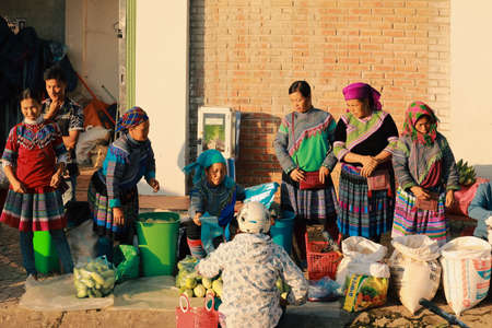 Bac ha, Vietnam - July 7, 2019 : Hmong women selling vetgetable in Bac Ha market, Northern Vietnam. Bac Ha is hill tribe market where people come to trade for goods in traditional costumesのeditorial素材