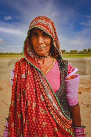 Jaisalmer, India - January 19, 2020 : Indian Rajasthani woman wearing traditional colourful clothing and jewelleryのeditorial素材