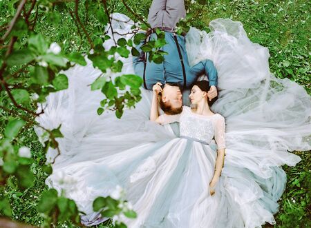 Beautiful newlyweds couple on a walk in a stunning Park on a spring summer day. analog film photographyの写真素材