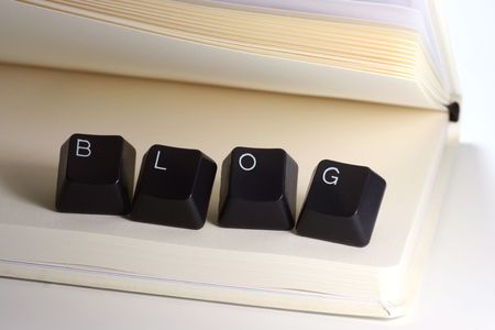 blog formed with keyboard keys on white notebookの写真素材