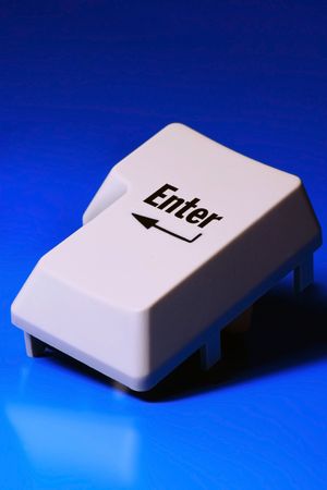 enter keyboard key on blue backgroundの写真素材
