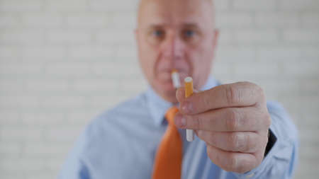 Image of a Businessman Who Smokes Relaxed and Offers a Cigarette to Another Personの写真素材