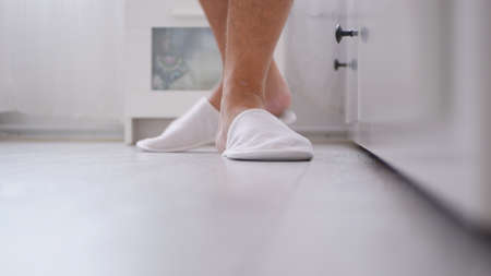 Image with a Man in the Bedroom Walking with Slippers in His Footsの写真素材