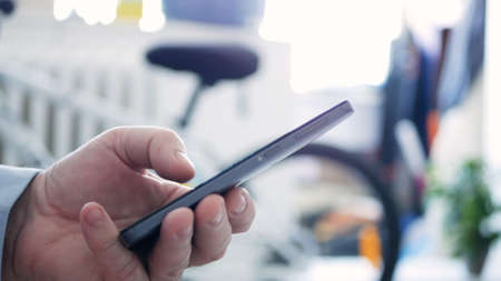 Closeup Man Hand Text Using a Cellphone and Access Network Online Applications, Senior Typing a...