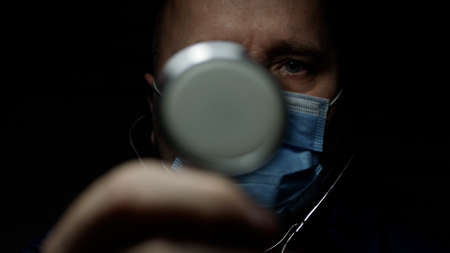 Doctor Wearing Protective Face Mask, Medical Person with Protection Equipment in a Quarantined Hospital Against COVID-19 Pandemicの写真素材