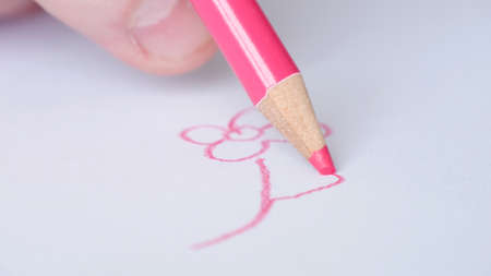 Image with a Person Drawing with a Colored Pencil on a White Piece of Paper a Flowerの写真素材