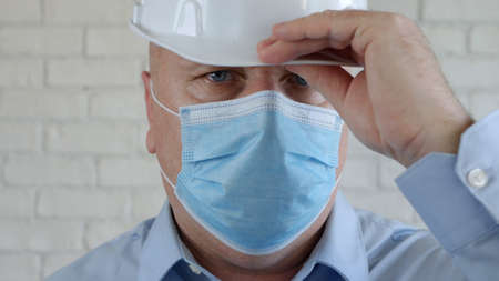 Confident Image with an Engineer Wearing Face Protection Mask Against Virusesの写真素材