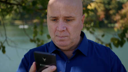 Image with a Person on the Street Sending a Message Using a Smartphoneの写真素材