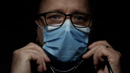 Doctor Wearing Protective Face Mask, Medical Person with Protection Equipment in a Quarantined...