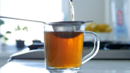 Image with Making a Hot and Aromatic Tea Using a Strainer and Natural Tea Leafsの写真素材