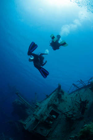 Divers Exploring Ship Wreckの写真素材
