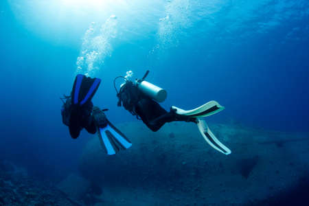 Divers Exploring Ship Wreckの写真素材