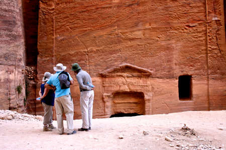 PETRA, JORDAN - DECEMBER 8 : Tourists observing the historical remains on Dec 8, 2009 in Petra, Jordan. のeditorial素材