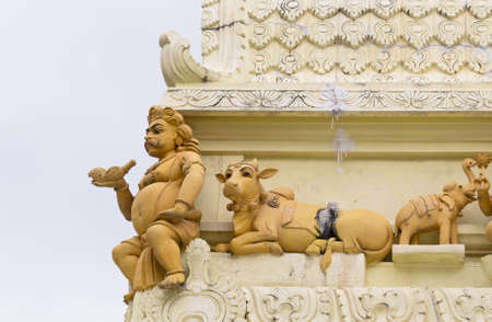 Man holding pipe with sacred cow and elephantの写真素材