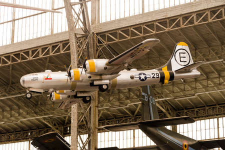 Vintage Airplane Inside A Hangar and Holding from the Roof
