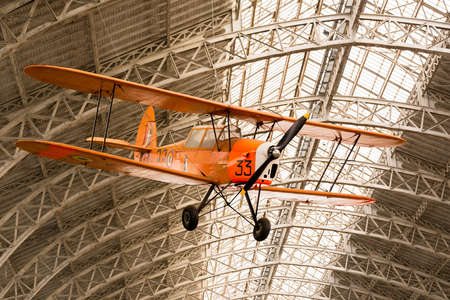 Vintage Airplane Inside A Hangar and Holding from the Roofのeditorial素材