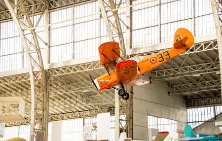 Vintage Airplane Inside A Hangar and Holding from the Roofのeditorial素材