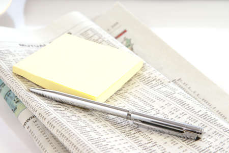 Financial or economy concept with newspaper, pen, and notepadの写真素材