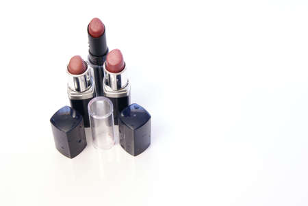 Three tubes of women's lipstick on whiteの写真素材