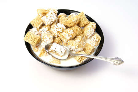 Cold breakfast cereal. Wheat squares with frosting in milk
