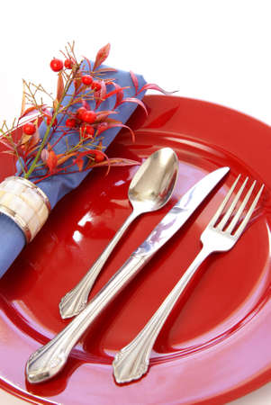 Elegant table setting in red and blue, with fresh sprigs of leaves and berriesの写真素材
