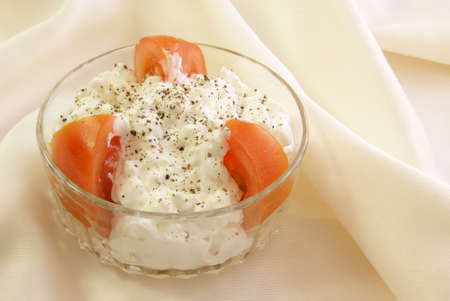 Cottage Cheese with tomato wedges and cracked black pepperの写真素材