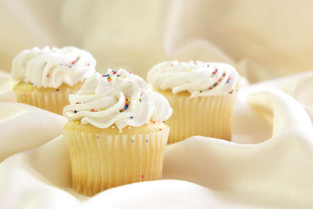 Close up of one cupcake in the front, with two others blurred behind.の写真素材
