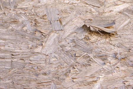 Plywood texture with peeling and curling strips of woodの写真素材