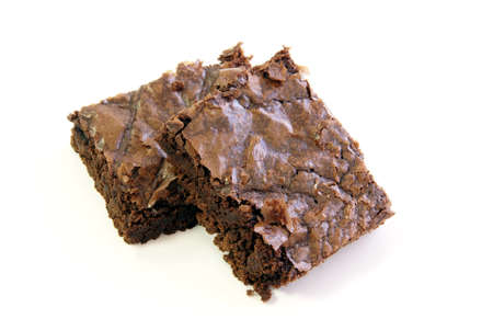 Two rich fudge brownie squares on a white backgroundの写真素材