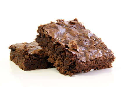 Two chewy chocolate fudge brownie squares on a white backgroundの写真素材