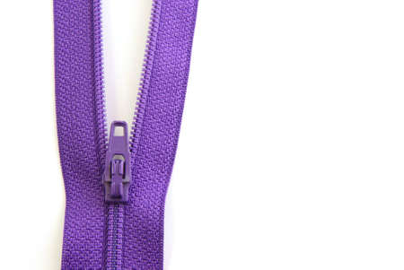 Purple zipper in partially opened V shape on white backgroundの写真素材