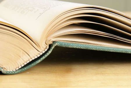 Open vintage book closeup on wooden tableの写真素材