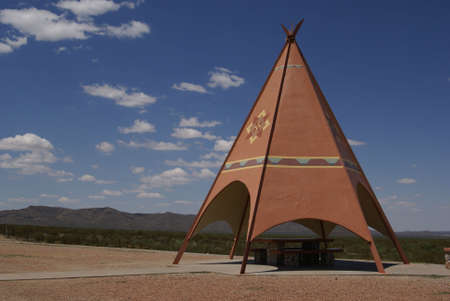 Texas picnic area with a burnt orange TePee shelter and mountains in the backgroundの写真素材
