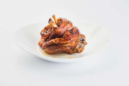 baked pork knuckle on a white backgroundの写真素材