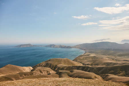 green hills against the blue seaの写真素材