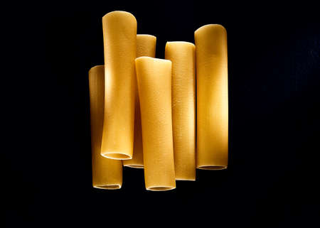 cannelloni in a composition on a black backgroundの写真素材