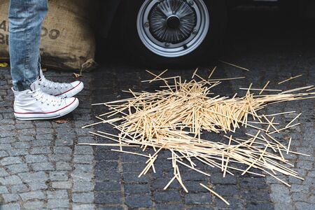 Messy wooden coffee spoons on floor with confused manの写真素材