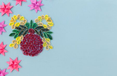Christmas quiling decoration elements on blue board for background compositionの写真素材