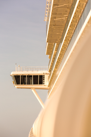 Upper captain deck on big luxury cruise view from passenger balcony in sunrise lightの写真素材