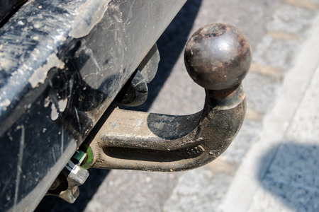 Old ball car hook conected to rusty chassis close up view