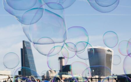 Soap bubble on City of London background as a metaphor for investment bubble on bonds and sharesの写真素材