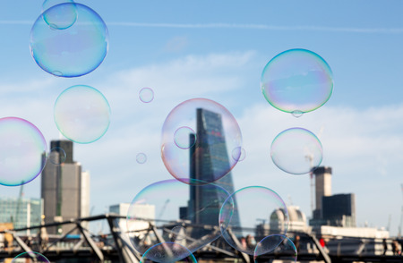 Soap bubble on City of London background as a metaphor for investment bubble on bonds and sharesの写真素材
